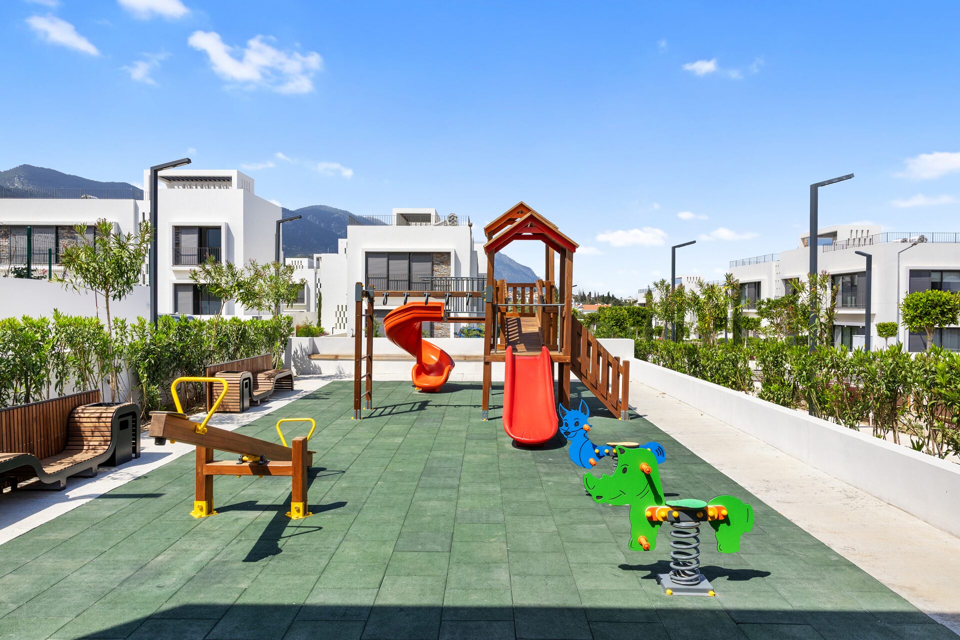 Mediterra children's playground with mountain backdrop